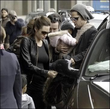 picture of Angelina and Brad getting into a car with their two children