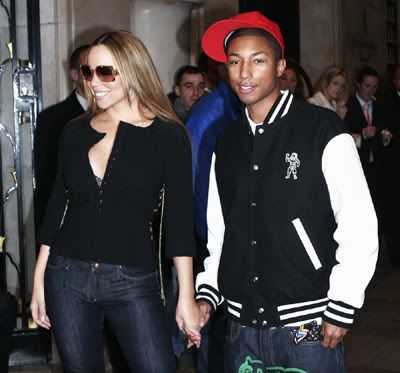 Mariah Carey in big sunglasses holding hands with a cute and young-looking Pharrell Williams
