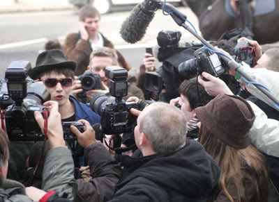 Pete Doherty arriving at court surrounded by cameras