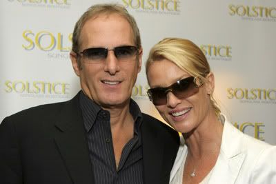 Nicolette Sheridan and Michael Bolton wearing sunglasses at an event