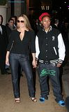 Mariah Carey holds hands with Pharrell Williams
