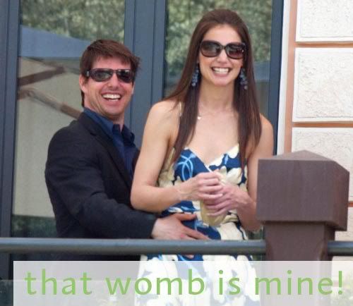 Tom holding Katie's stomach, with the caption - that womb is mine!