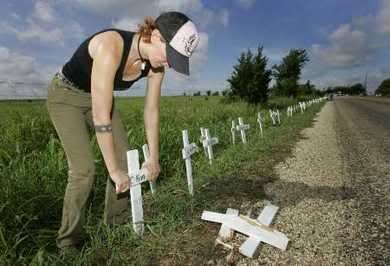 replacing the damaged crosses at Camp Casey