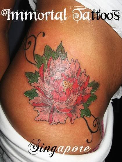 Mahony Flower Designed in Creative Tribal Tattoo Pictured in the Lower Back of A Pretty Sexy Girl 