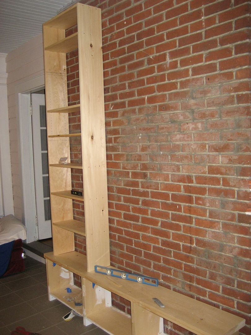 When the first bookcase was complete, I lifted it into place. These bookcases were kinda big and bulky. I slept well at the end of each day.  :) 