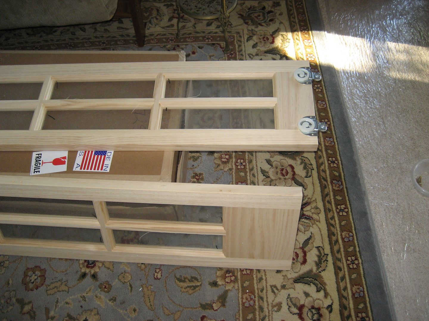 Next, I affixed the corresponding rollers to the top of these wooden french doors.