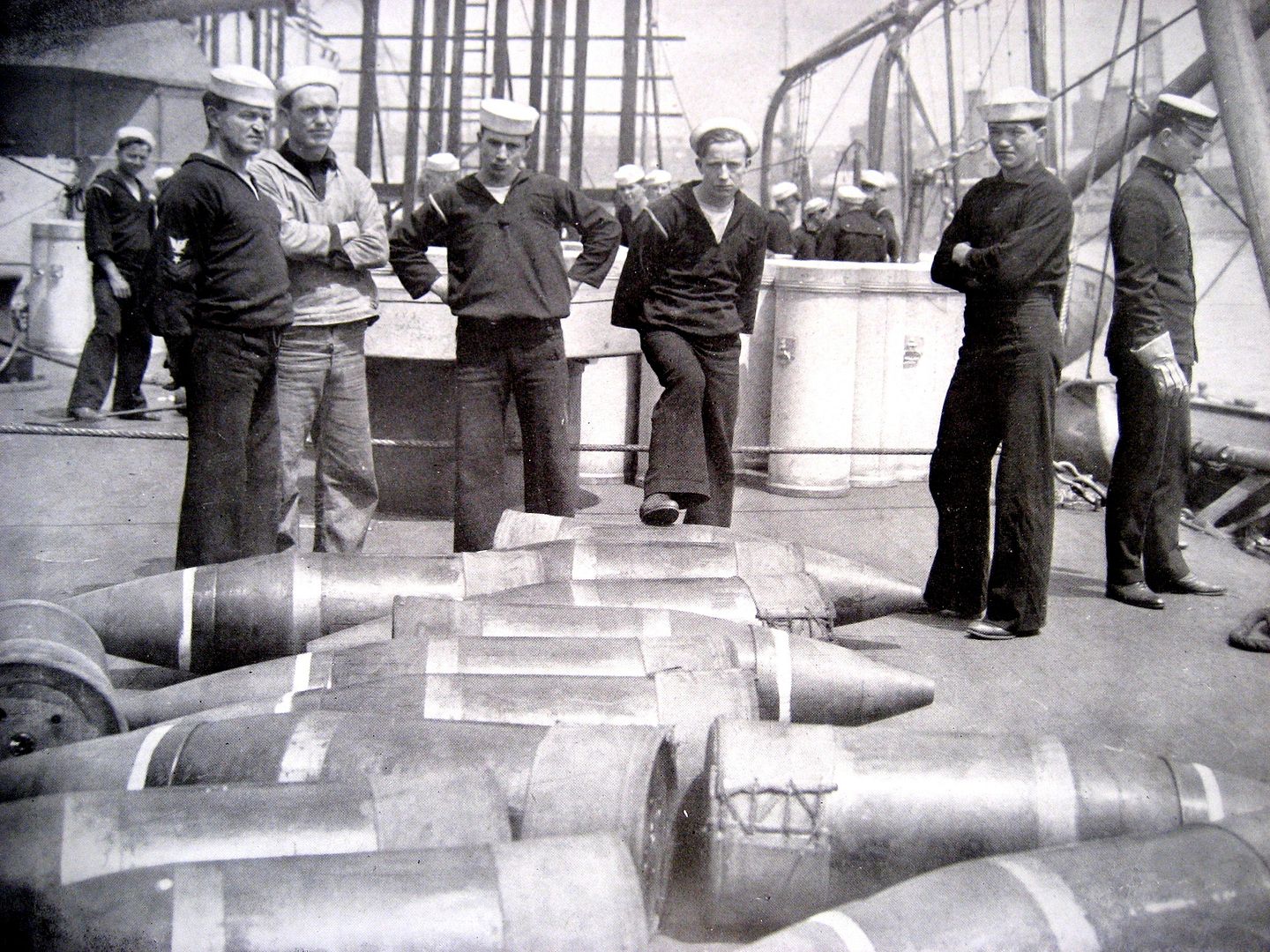 Sailors on board an unnamed battleship, with 14-inch shells which were just supplied by a lighter.