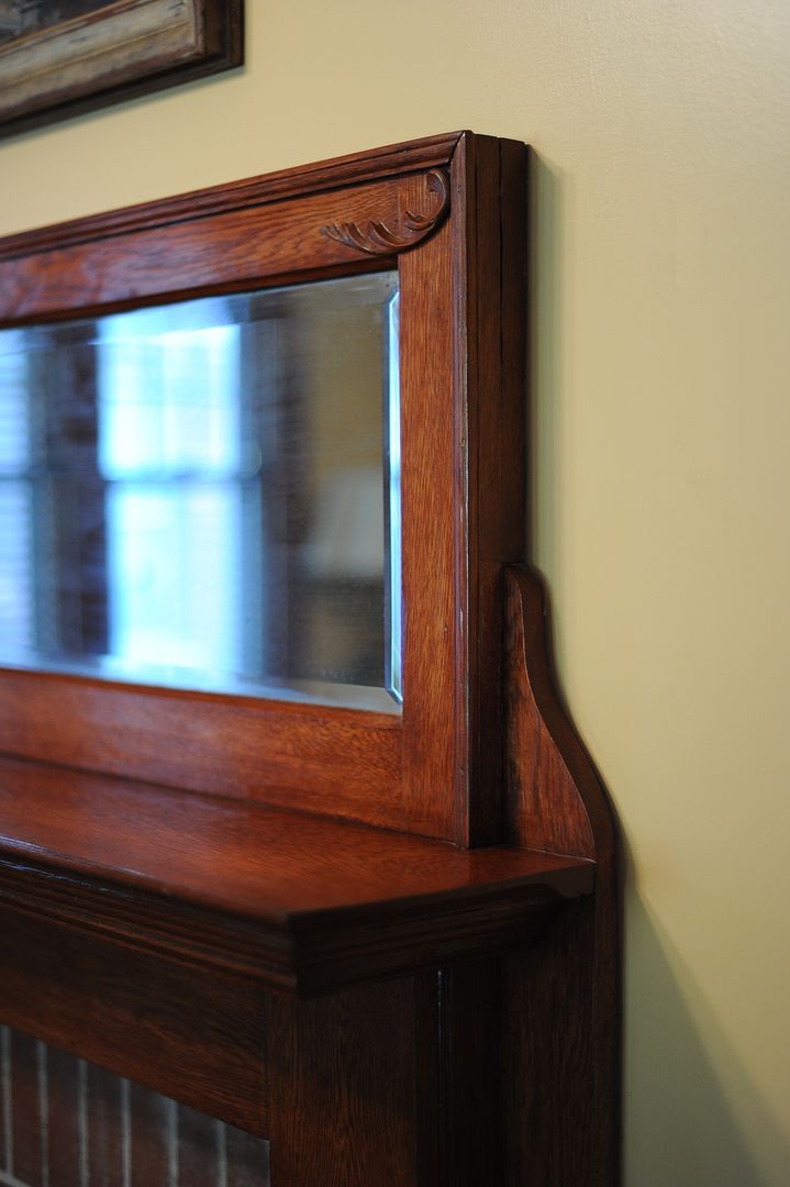 Close-up of mantel detail and beveled mirror. 