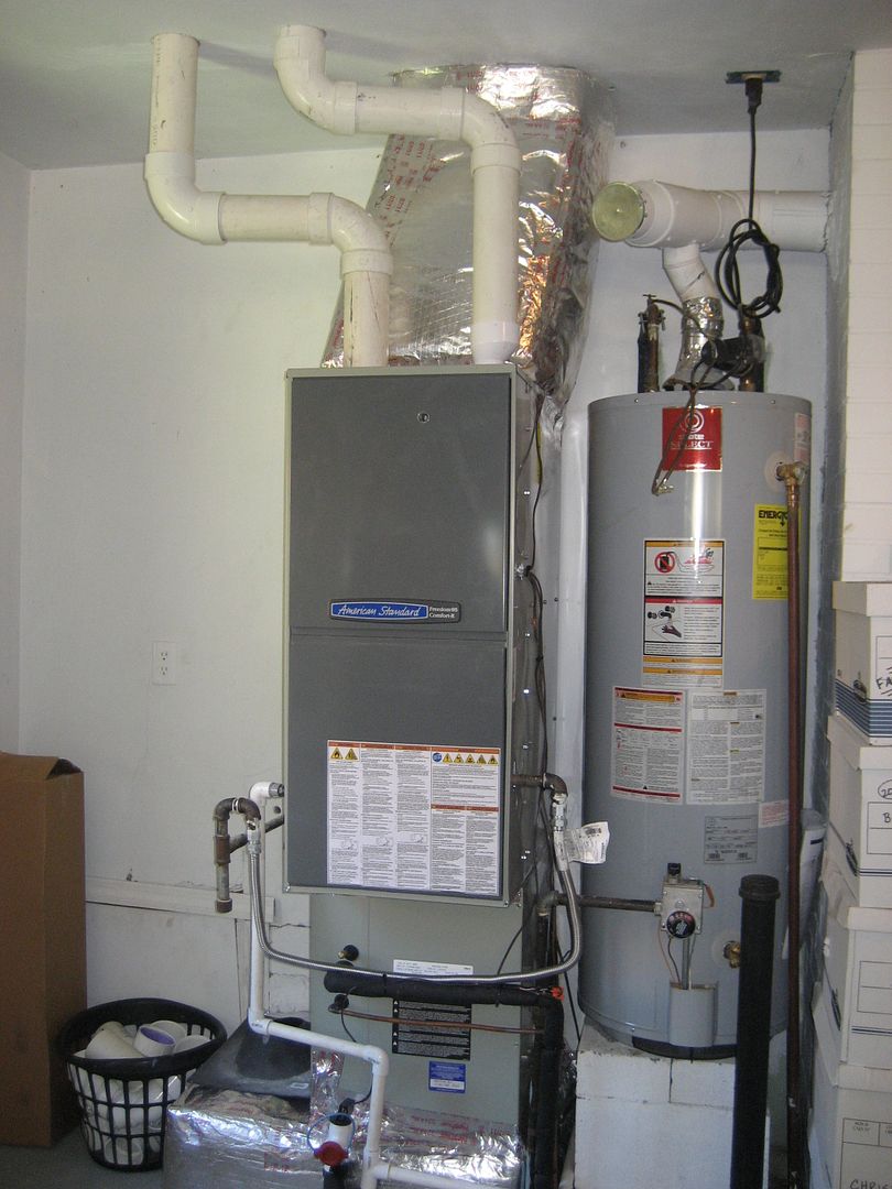 The old is gone and the new is in place. And what a dandy new furnace it is. The AFUE is 95% and the chimney flue is no longer in use. In its place are plastic pipes; one for exhaust and one for fresh-air (for combustion).