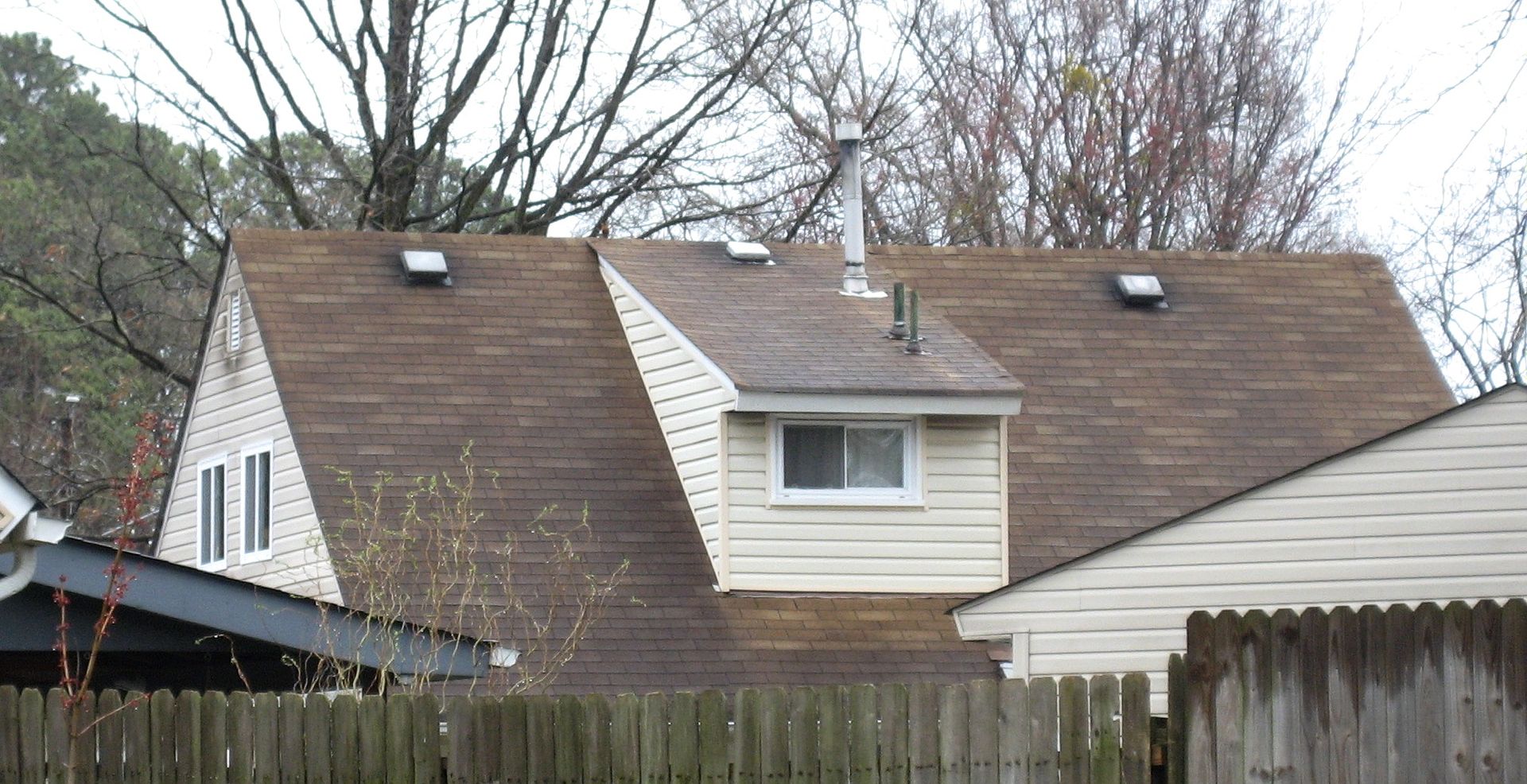 Just like its Levittown twin, the house in Norfolk has a bathroom dormer (on the rear) with an off-center window.