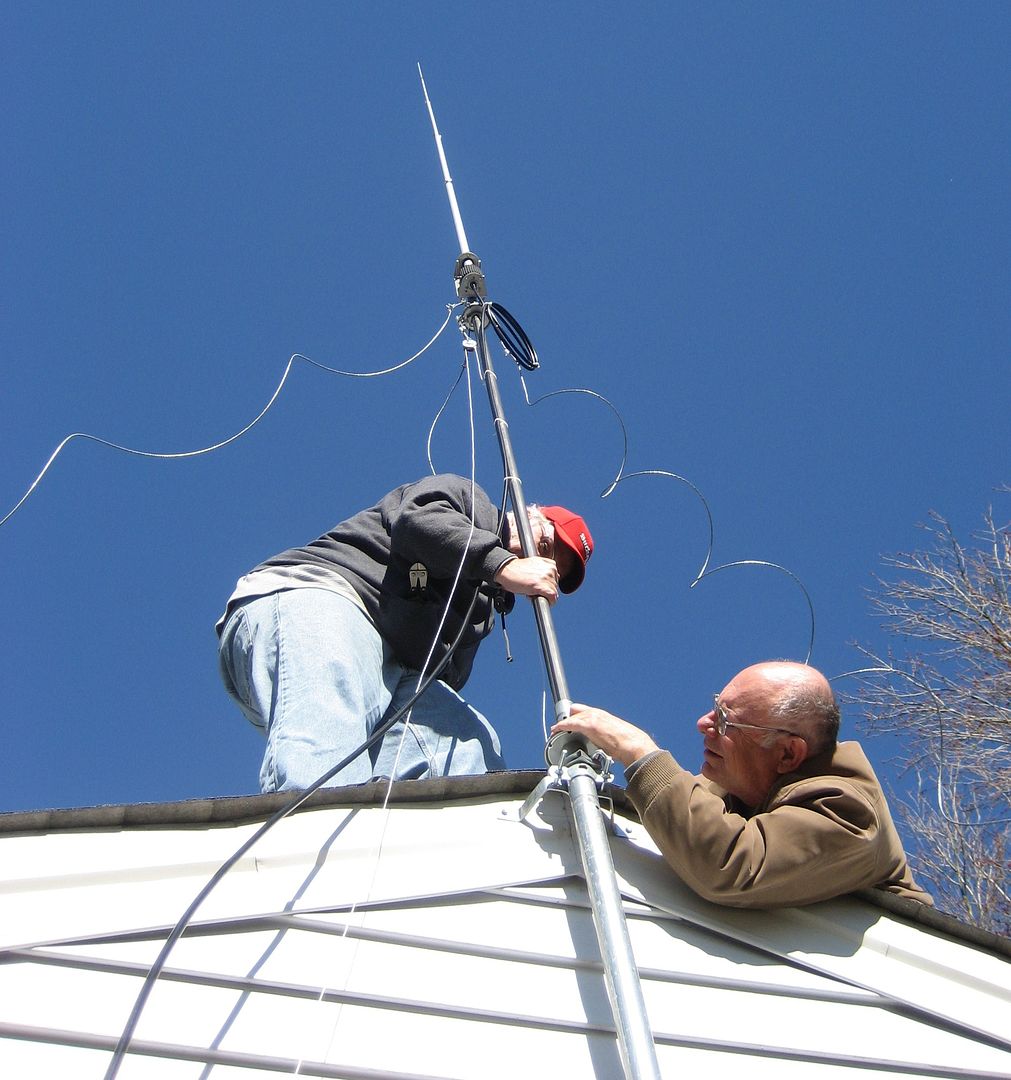 Jim and Milton (fellow hams) install a new antenna. 