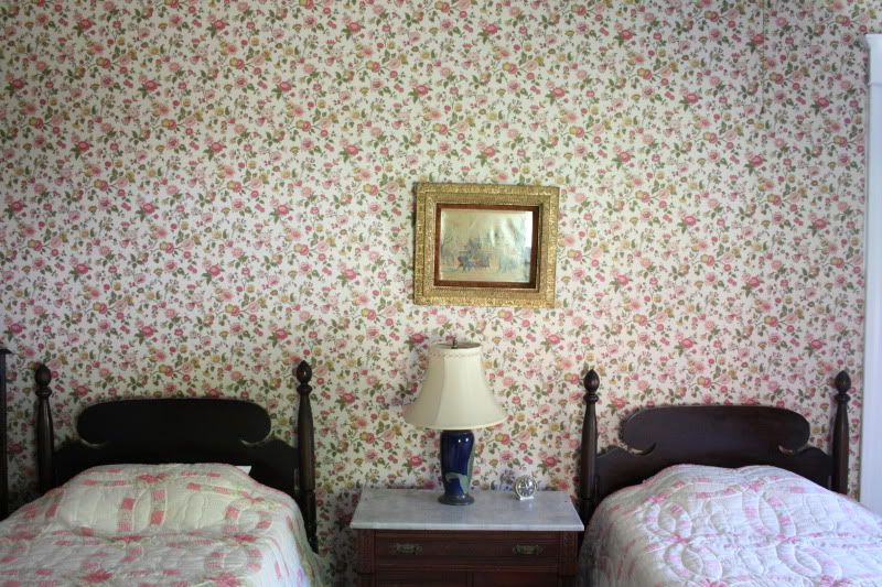 twin beds with vintage wallpaper
