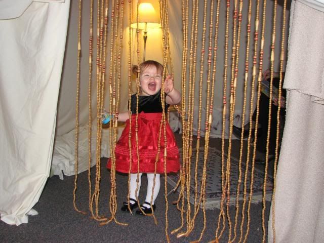 She loved playing wiht the bead curtain at the story time tent!