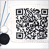 A QR code knitted with black and white yarn. A QR code knitted with black and white yarn.
