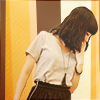 A brunette girl with wavy hair and bangs in front of an abstract background. A brunette girl with wavy hair and bangs in front of an abstract background.