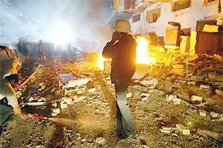 A man stands near the ruins of the Mount Lebanon Hotel after the attack in central Baghdad -Thu 18 Mar 2004