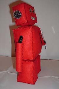 Side view of a robot doll made from red felt. Image hosted by Photobucket.com