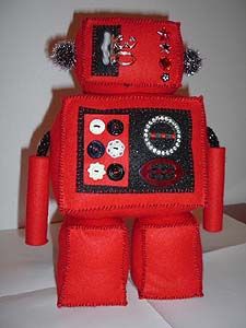 Back view of a robot doll made from red felt. Image hosted by Photobucket.com