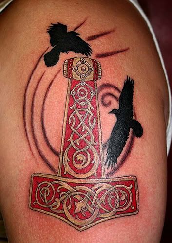 It's a tatoo of Mjöllnir (Thor's Hammer) with Huginn and Muninn who were 