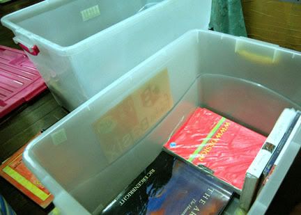 Packing books in plastic storages