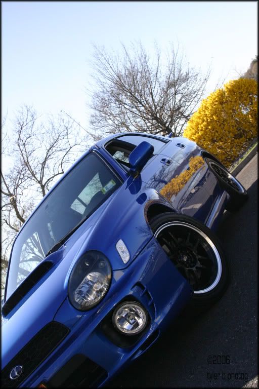 black wheels on blue subaru