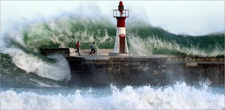 A giant wave crashes over the sea wall at Kalk Bay near Cape Town, South Africa, Aug 27. The wave washed the two people off the wall. Both were rescued. Storms drove the waves that day to height of about 30 feet.