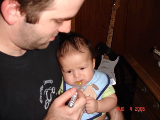 Daddy doing the honors of feeding the first spoonful.