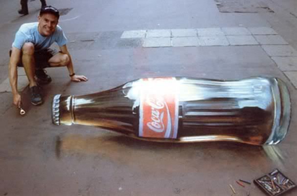 Goodness! i think this is the amazing artist that does all the amazing stuffs on such ordinary pavements. The coke looks sooooo real xD