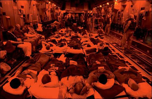 In the Cargo Hold of a C-17 Aircraft, Soldiers Treated at the Air Force Theater Hospital at Balad Air Base, North of Baghdad, Await Evacuation to a Military Hospital in Landstuhl Germany