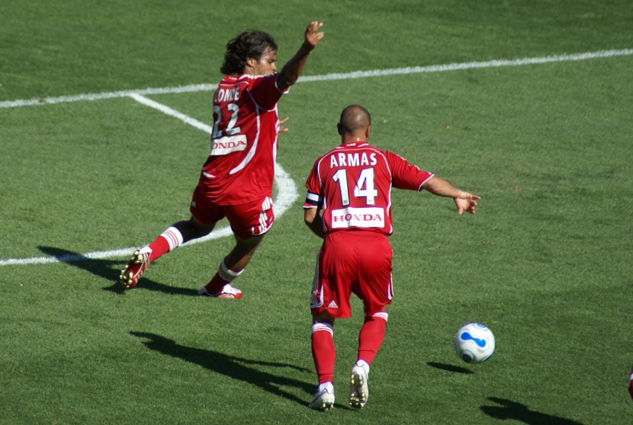 Fire defenseman Wilman Conde from Colombia rushes to the ball along with Midfielder and Captain Chris Armas