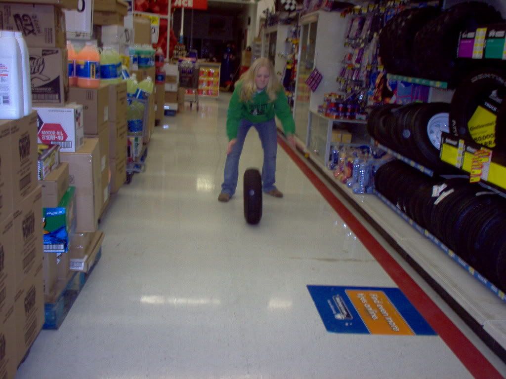 tire rolling photo: Ashley rolling a tire down the the aisle Walmart IM000321.jpg