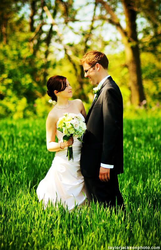 bride and groom in a field of grass