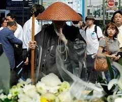 A Buddhist monk prays for victims before a makeshift altar at Tokyo's shopping and subculture town of Akihabara.