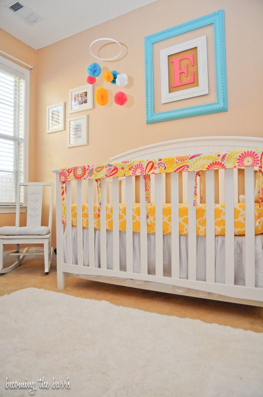 pink yellow turquoise nursery with diy nursery items and faux fur rug in nursery