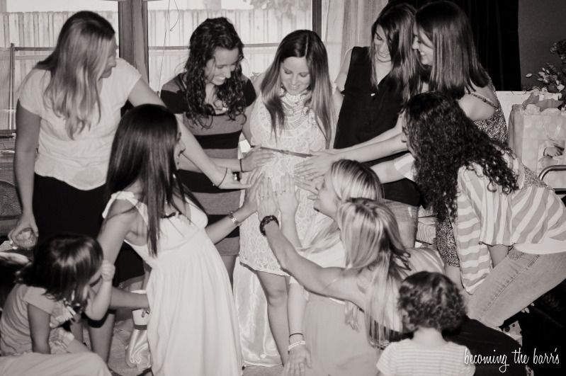 friends touching baby belly baby shower photography