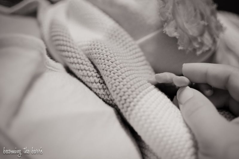 newborn hand touching mommys hands