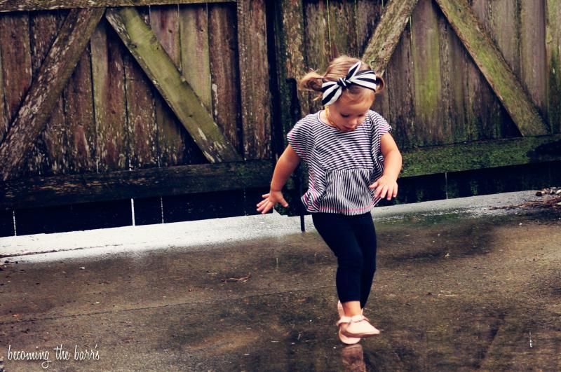 toddler playing in the rain