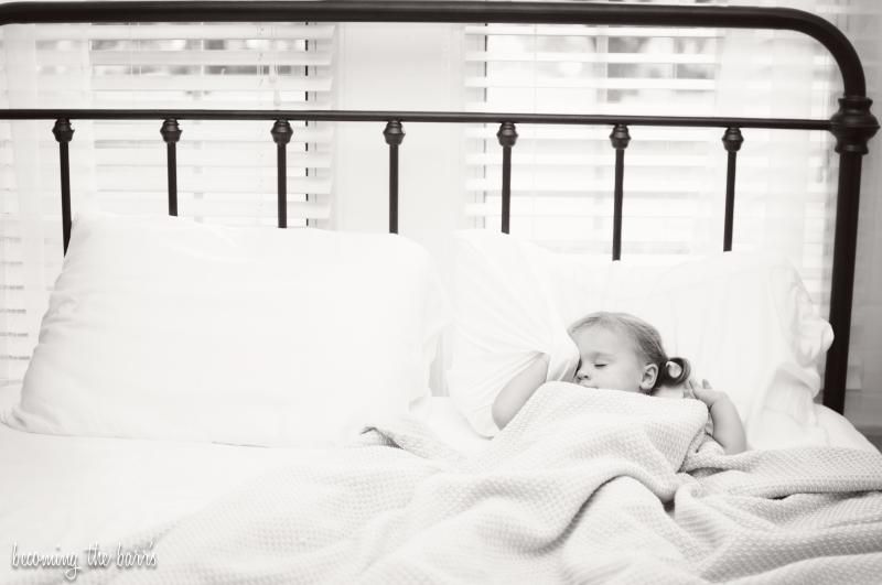 toddler laying in mommy and daddys bed