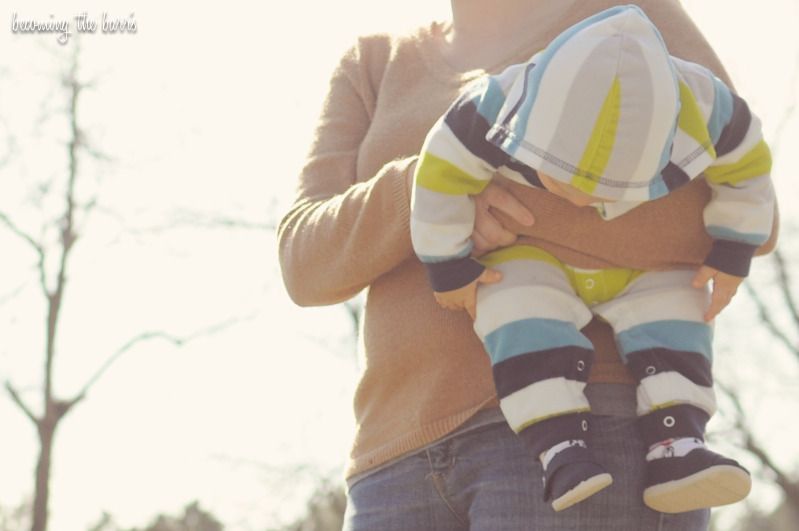 mommy holding baby in the park photo