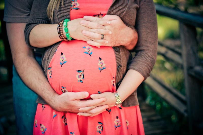 maternity photo pose arms locking around belly; unique maternity pose