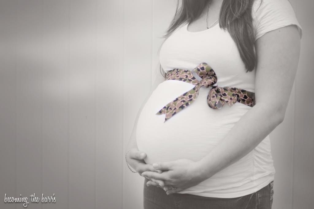 maternity photo with army ribbon around belly