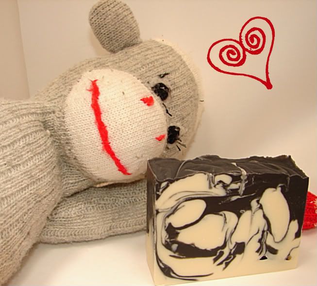 sock monkey and a bar of black and white almond soap
