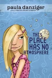 light blue cover with cartoon image of girl in pink top with thick blond hair over on side of her face, moon in background