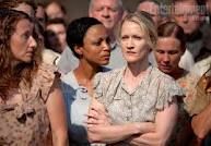 Group shot of women from District 12 in their simple clothing