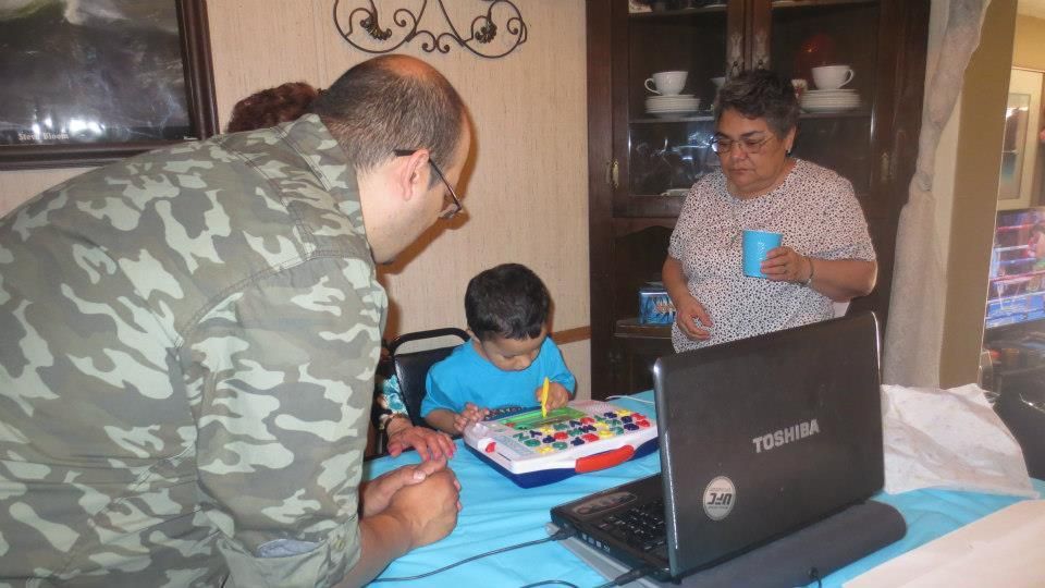 Opening our present from Grandma and Grandpa Tinez while skyping with Hauntie, Shirley and Memo. photo 543708_10152720260255417_654050351_n.jpg