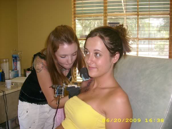  her chest) and touching up her first pelvic tattoo from a few years ago.