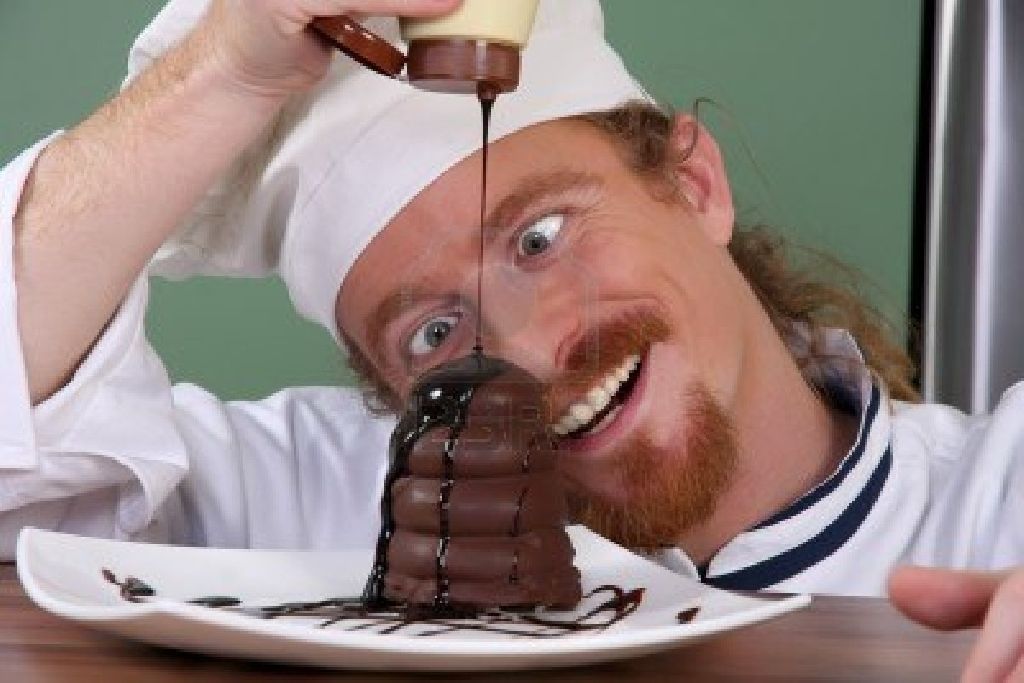funny-young-chef-added-chocolate-sauce-at-piece-of-cake-royalty.jpg