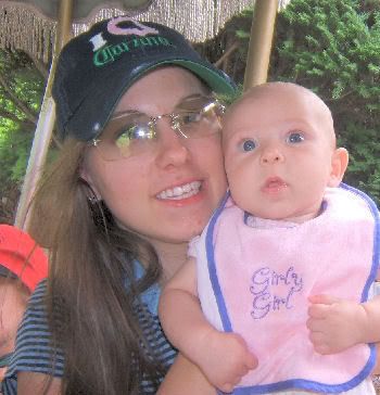 Eryn holding <b>Lily while</b> riding on the carousel in the Indonesian Rainforest. - 07