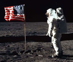 Apollo 11 astronaut Buzz Aldrin stands before an American Flag erected on the lunar surface