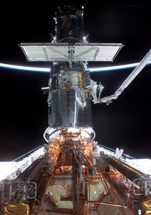 An astronaut works on Hubble during the last service mission, which took place with space shuttle Columbia on 2002's STS-109 flight.
